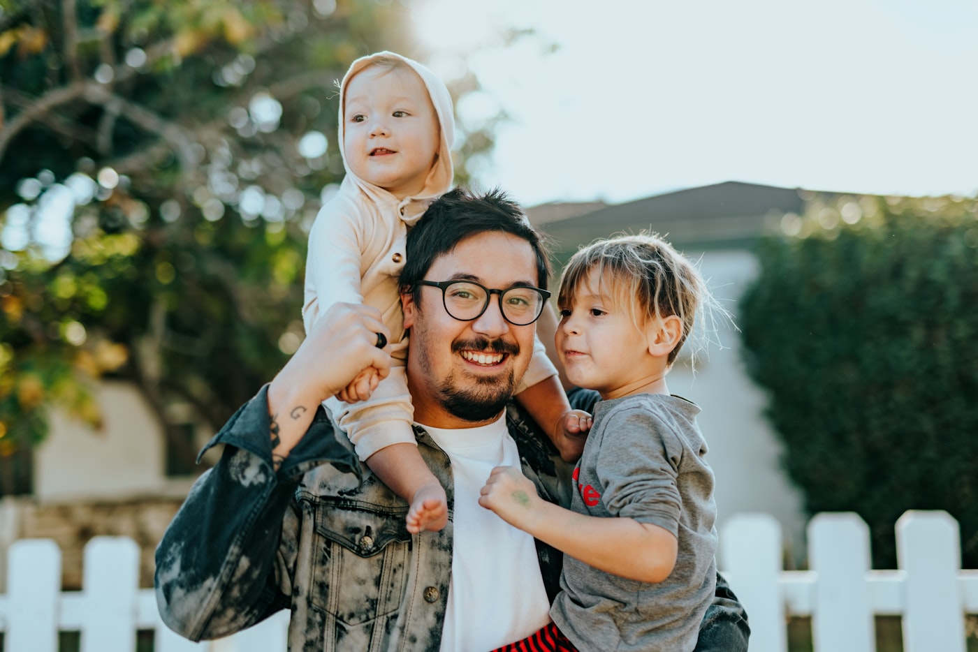Father with his kids outside their home
